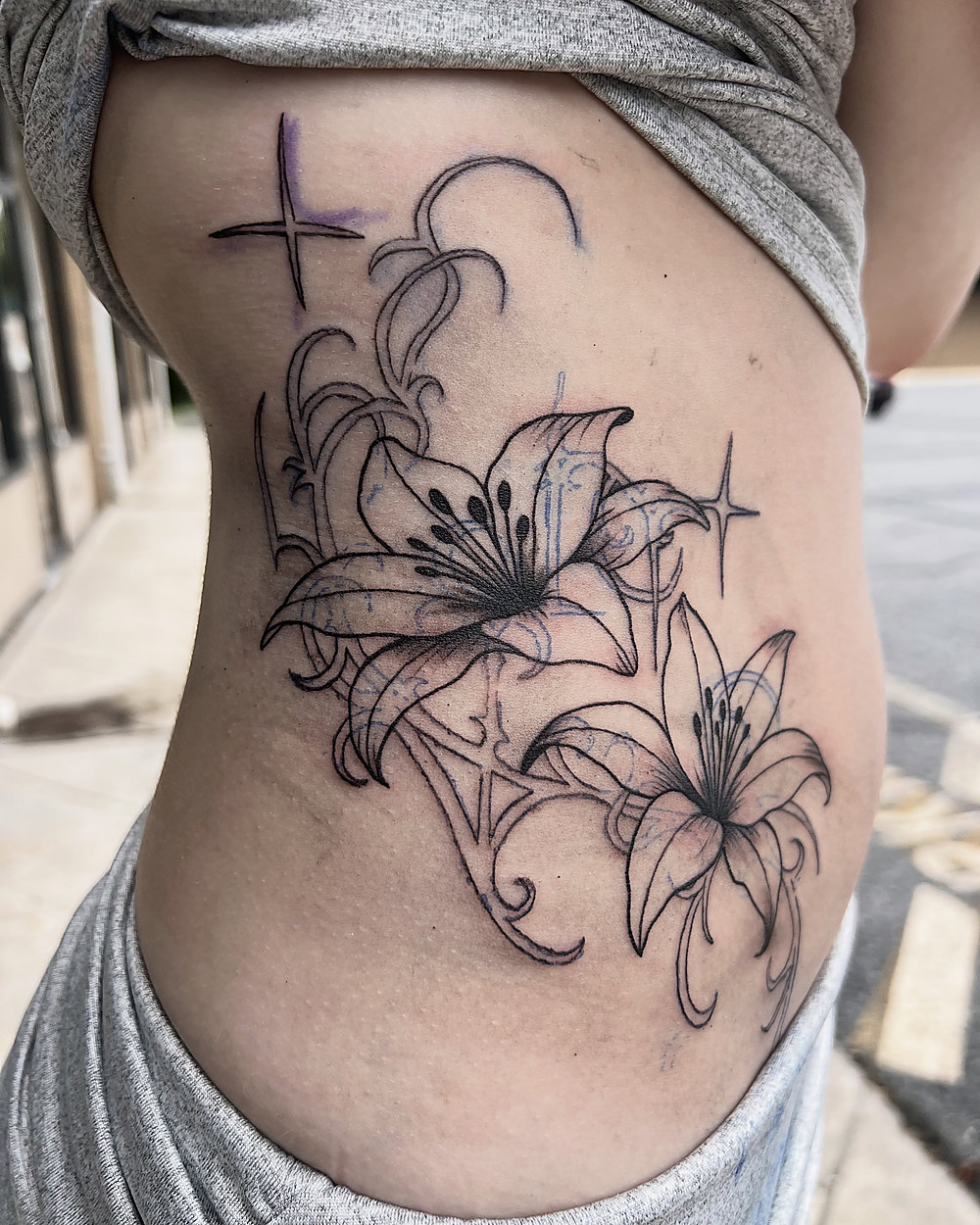 Fine line lilies across the ribs, by Kevin Lewis