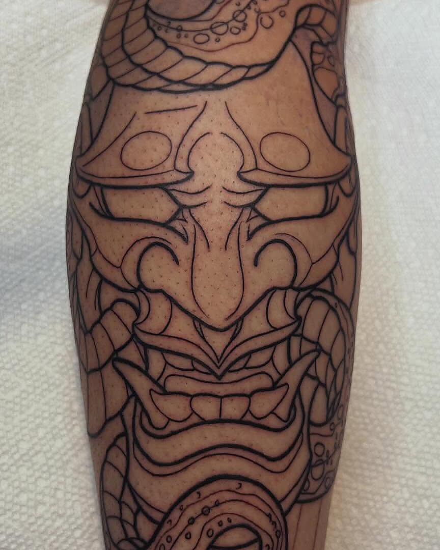 A mask and snake in bold black linework, by Kevin Lewis