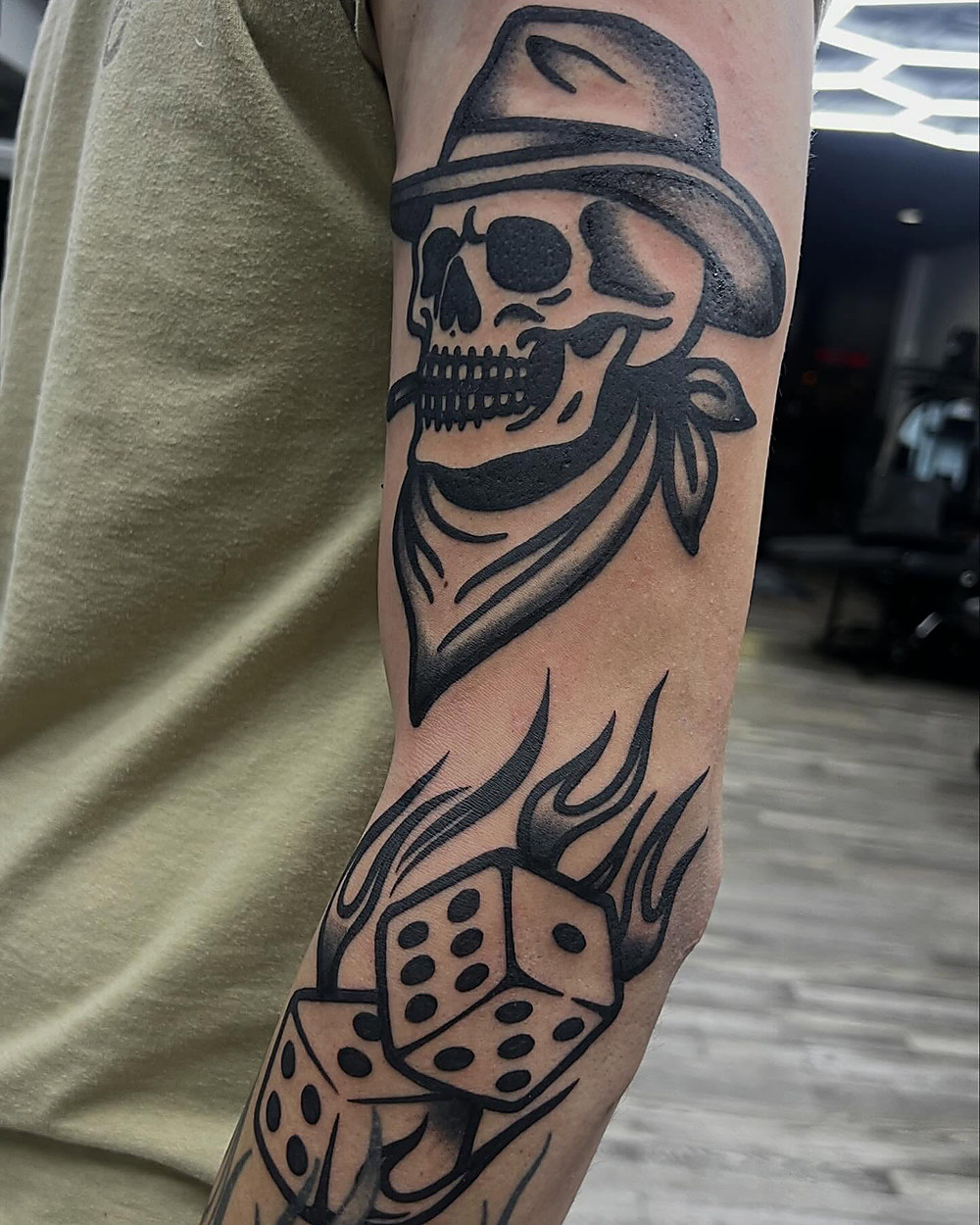Traditional skull in a hat with dice, by Kevin Lewis