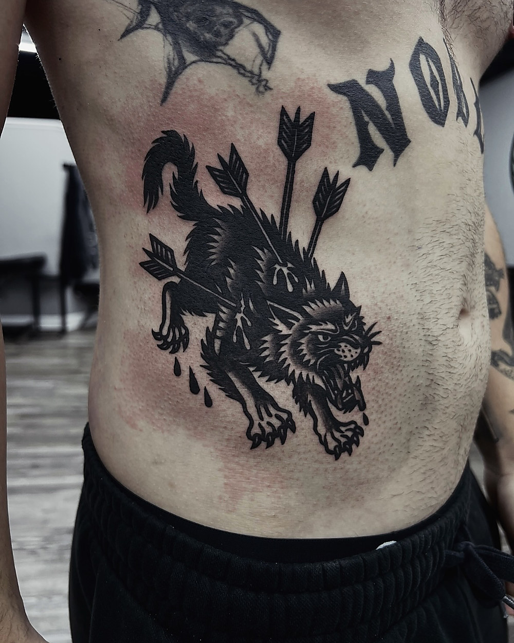 Bold blackwork wolf with arrows, by Kevin Lewis