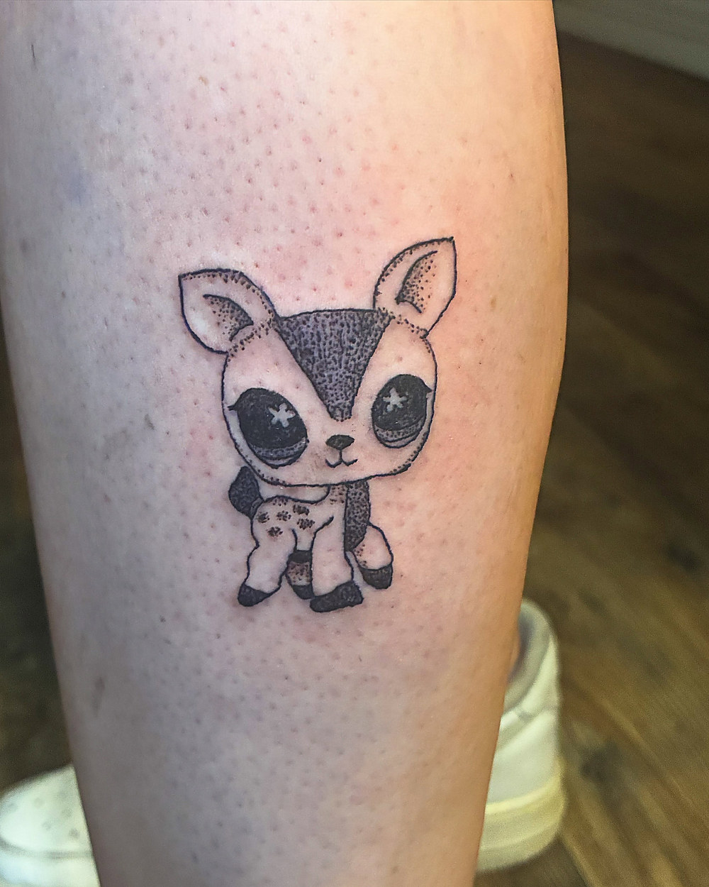A little fawn in fine line on a calf, by Miah