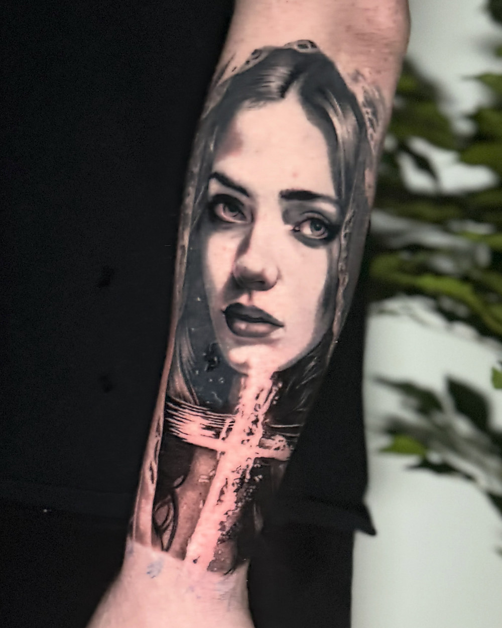 Black and grey portrait of a woman with a cross, by Owen Lewis